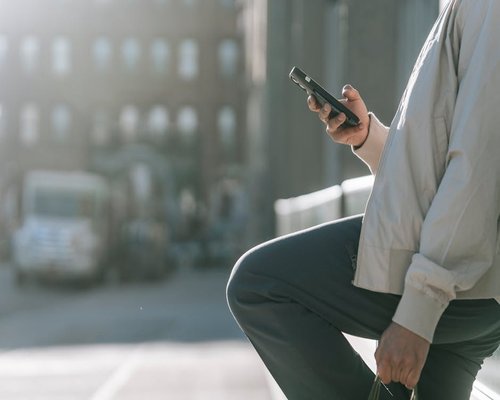 Person holding a smartphone outdoors