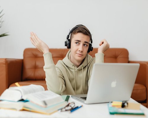 Student looking away from laptop screen